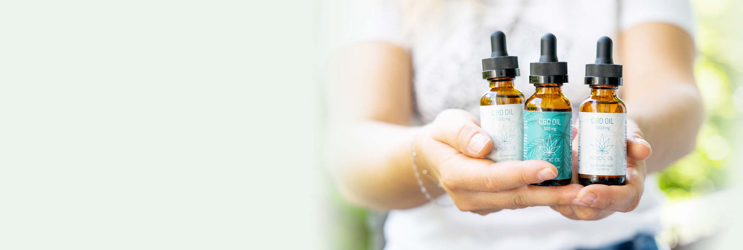 3 bottles of cod oil held in hand