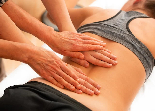 A woman receives a back massage to help with her back pain