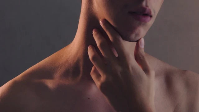 person reaching towards its neck where the thyroid is