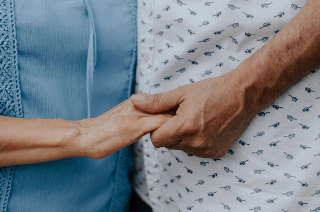 A senior couple holding hands