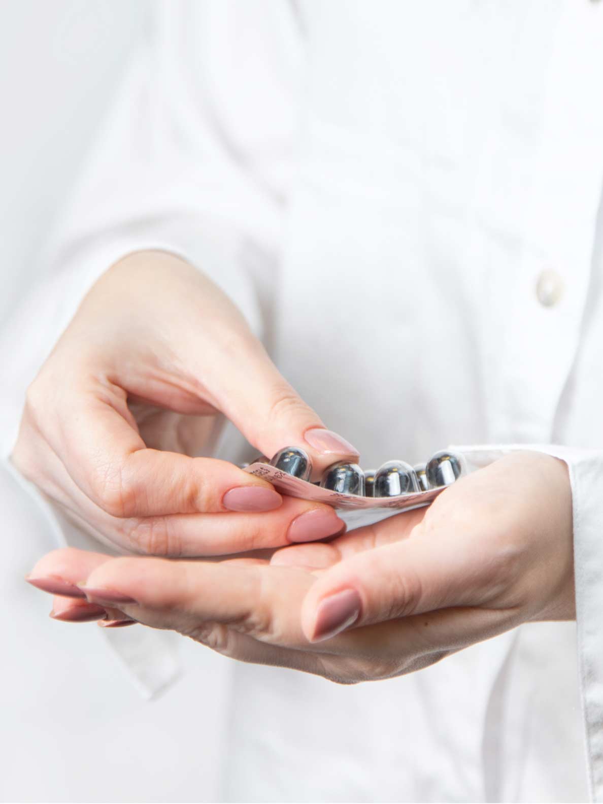 CBD capsules in package held with hands